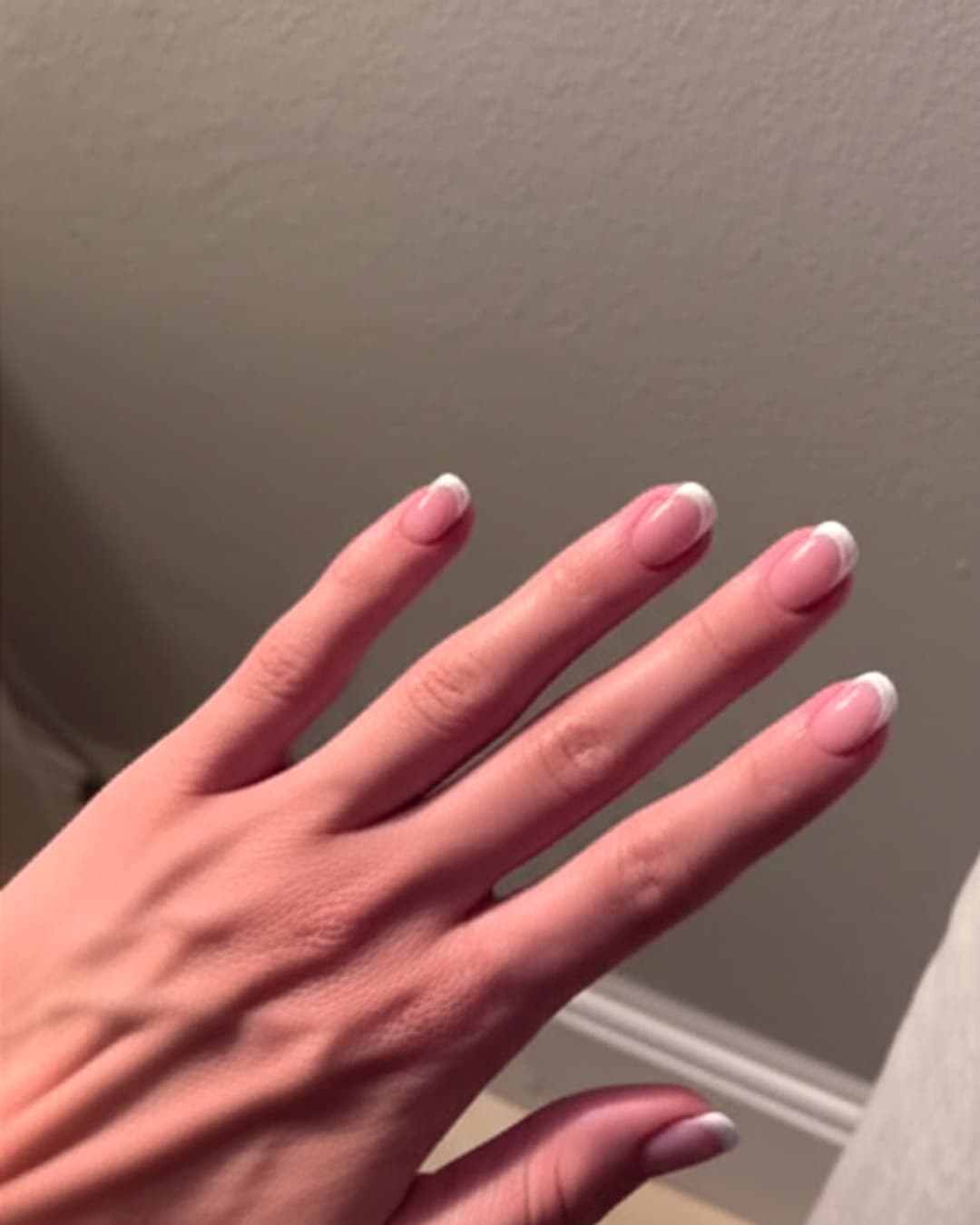 Thin white French tips on short natural nails